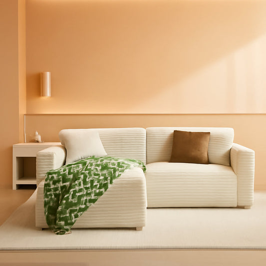 White corduroy 108-inch cloud sectional sofa with chaise in a warm living room