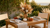 Coastal dried pampas bouquet as a centerpiece on an outdoor harvest table